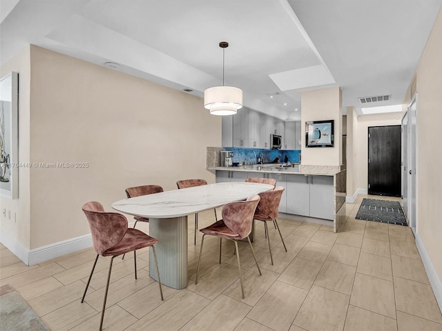 dining room featuring baseboards and visible vents