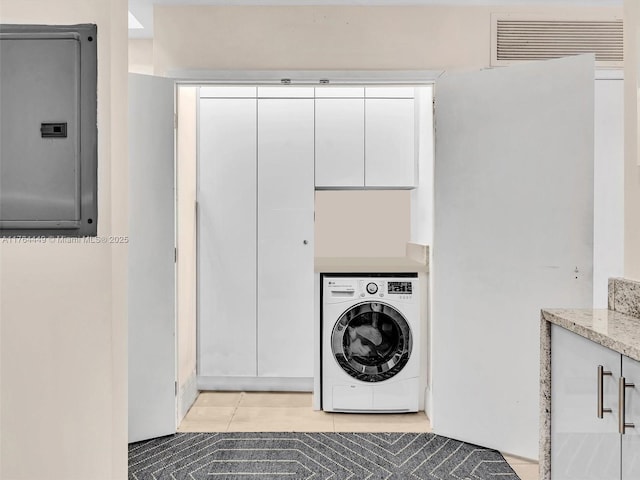 laundry room with light tile patterned floors, visible vents, washer / dryer, electric panel, and cabinet space