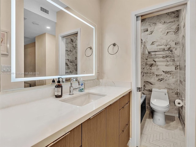 full bathroom with vanity, toilet, and visible vents