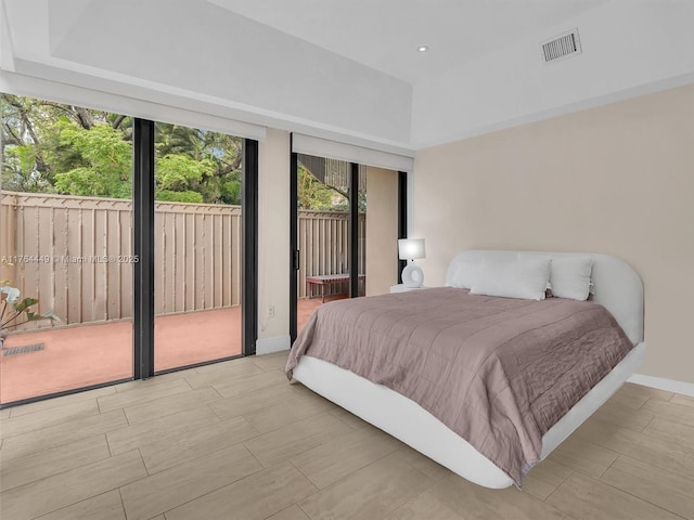 bedroom with access to exterior, baseboards, and visible vents