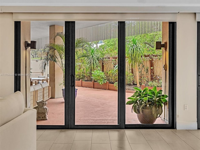 doorway to outside featuring tile patterned floors