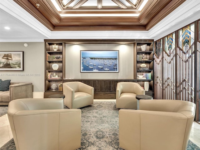 living area with built in shelves, a tray ceiling, and ornamental molding