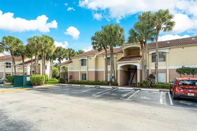 815 W Boynton Beach Blvd Unit 6-103, Boynton Beach, FL 33426 - view of building exterior featuring uncovered parking and stairs