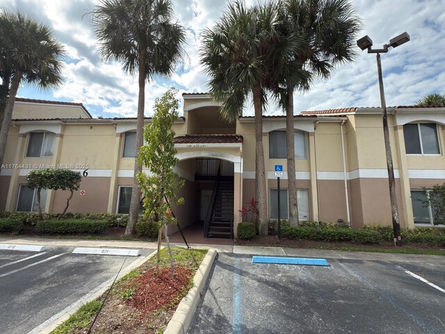 815 W Boynton Beach Blvd Unit 6-103, Boynton Beach, FL 33426 - view of property with uncovered parking and stairway