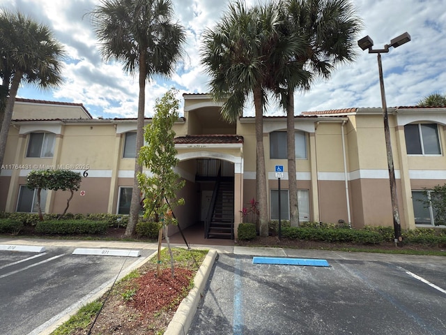 815 W Boynton Beach Blvd Unit 6-103, Boynton Beach, FL 33426 - view of building exterior with uncovered parking and stairway