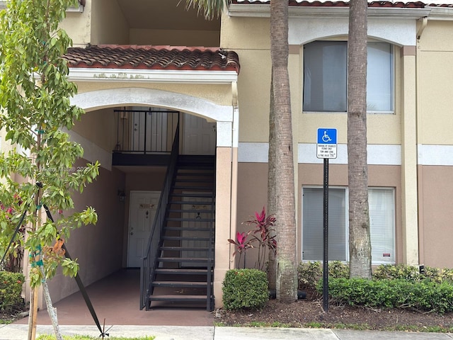 815 W Boynton Beach Blvd Unit 6-103, Boynton Beach, FL 33426 - doorway to property featuring a tile roof and stucco siding