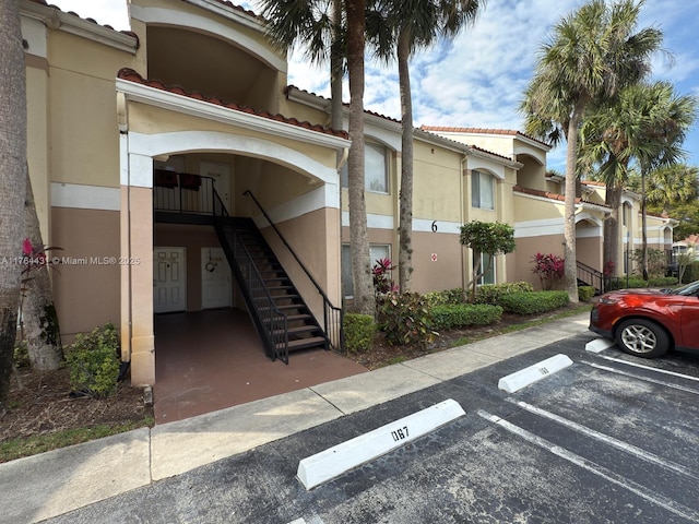 815 W Boynton Beach Blvd Unit 6-103, Boynton Beach, FL 33426 - view of building exterior featuring uncovered parking and stairs