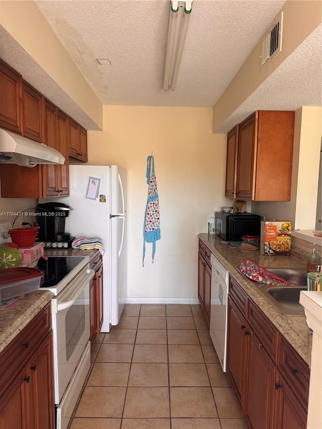 815 W Boynton Beach Blvd Unit 6-103, Boynton Beach, FL 33426 - kitchen featuring white appliances, under cabinet range hood, a textured ceiling, brown cabinetry, and baseboards