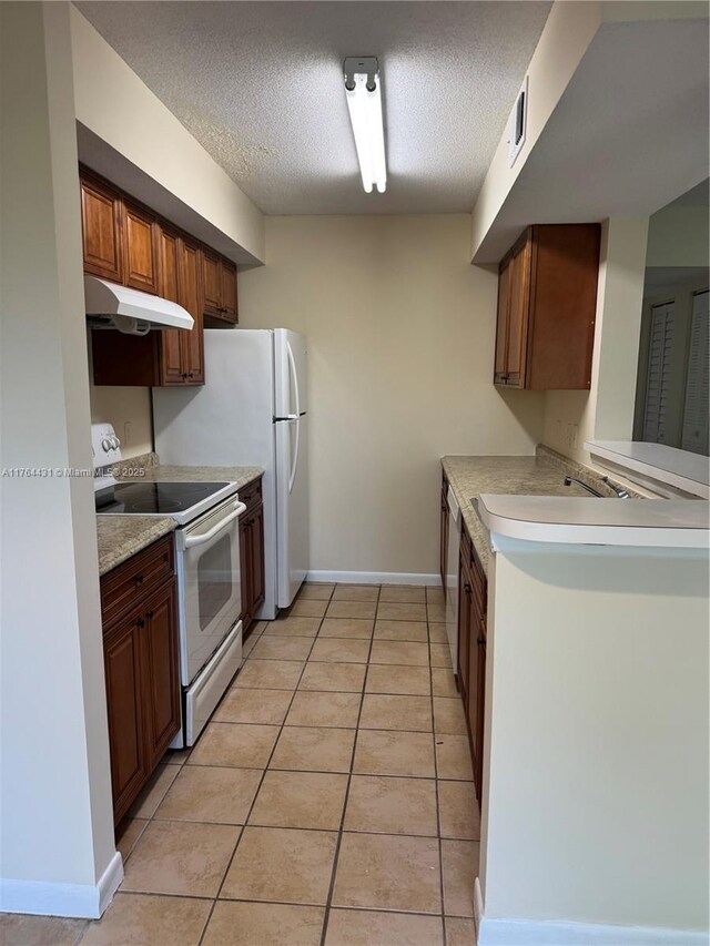 815 W Boynton Beach Blvd Unit 6-103, Boynton Beach, FL 33426 - kitchen featuring white range with electric cooktop, under cabinet range hood, a textured ceiling, light countertops, and light tile patterned floors