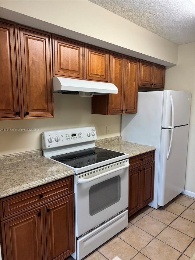 815 W Boynton Beach Blvd Unit 6-103, Boynton Beach, FL 33426 - kitchen featuring white appliances, under cabinet range hood, light countertops, a textured ceiling, and light tile patterned floors