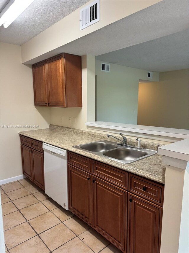 815 W Boynton Beach Blvd Unit 6-103, Boynton Beach, FL 33426 - kitchen with white dishwasher, light tile patterned flooring, light countertops, a peninsula, and a textured ceiling