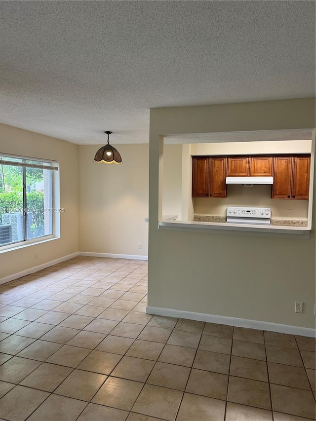 815 W Boynton Beach Blvd Unit 6-103, Boynton Beach, FL 33426 - kitchen featuring stove, under cabinet range hood, a textured ceiling, light countertops, and light tile patterned floors