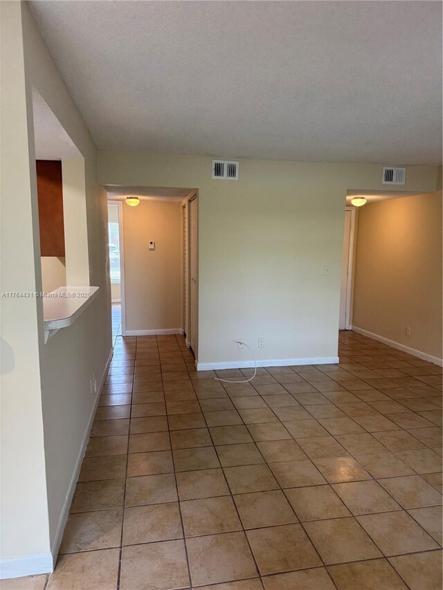 815 W Boynton Beach Blvd Unit 6-103, Boynton Beach, FL 33426 - spare room featuring light tile patterned floors and baseboards