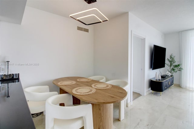 dining area featuring visible vents and marble finish floor