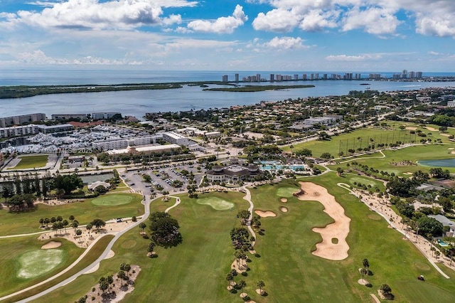 aerial view featuring golf course view, a view of city, and a water view