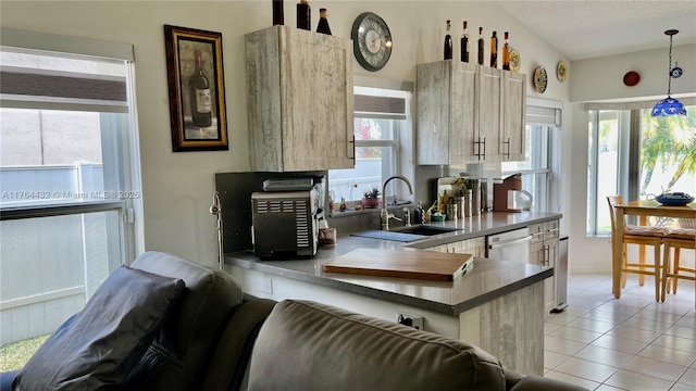 kitchen with light tile patterned floors, plenty of natural light, and a sink