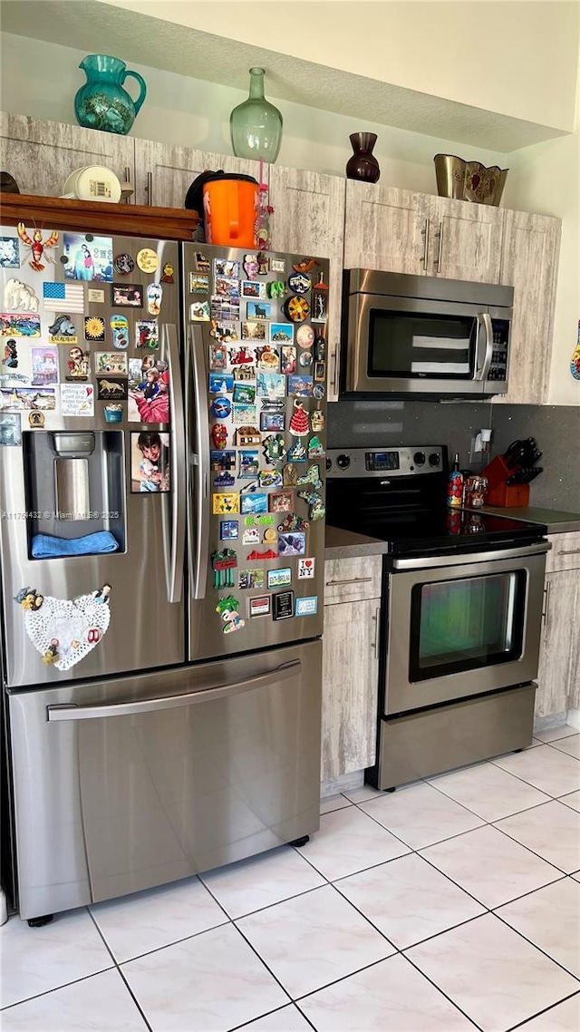 kitchen featuring light tile patterned floors and appliances with stainless steel finishes