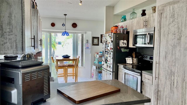 kitchen featuring pendant lighting and appliances with stainless steel finishes