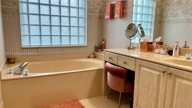 full bathroom with tile patterned floors, vanity, and a garden tub