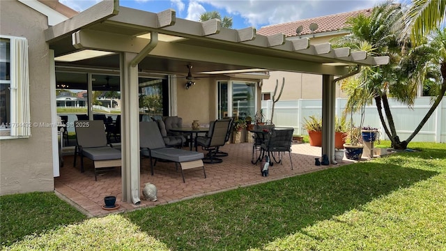 view of patio featuring a ceiling fan and fence