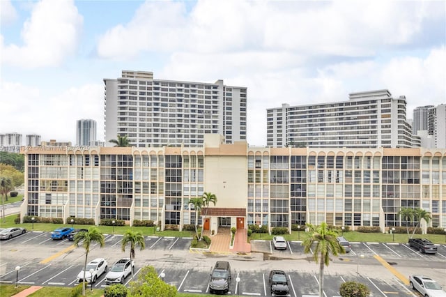 view of property with a city view and uncovered parking