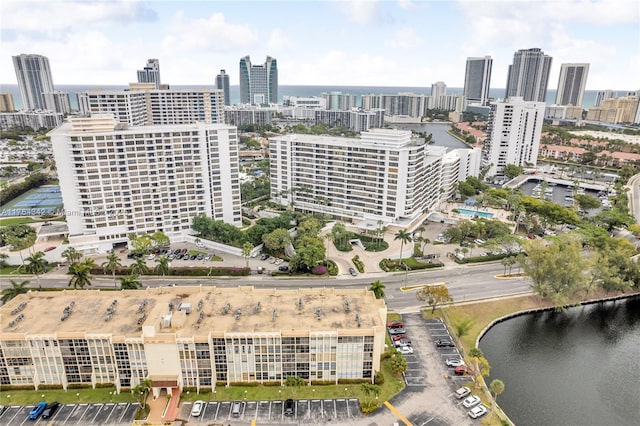 birds eye view of property featuring a water view and a city view