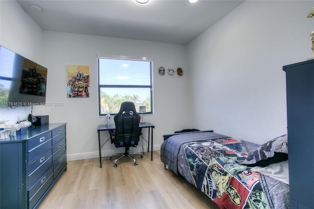 bedroom with baseboards and light wood-style floors