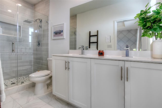 bathroom with double vanity, a stall shower, a sink, toilet, and marble finish floor