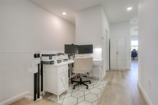 home office with light wood finished floors, recessed lighting, and baseboards