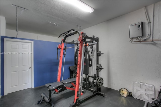 exercise room featuring a textured ceiling