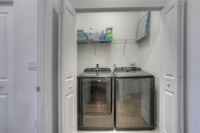 washroom featuring washing machine and clothes dryer and laundry area