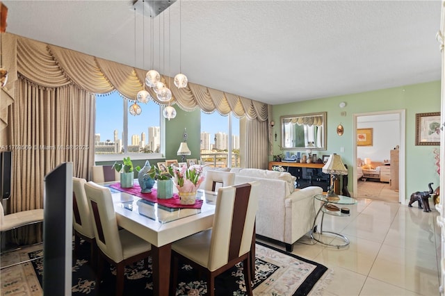 tiled dining area featuring a city view and a textured ceiling