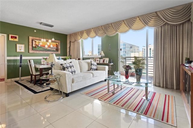 living area with a city view, a notable chandelier, tile patterned flooring, and a textured ceiling