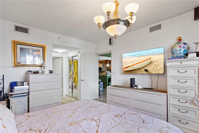 bedroom featuring visible vents and a chandelier