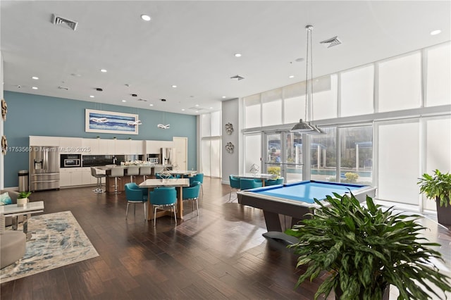 recreation room featuring pool table, a high ceiling, dark wood-style floors, and visible vents