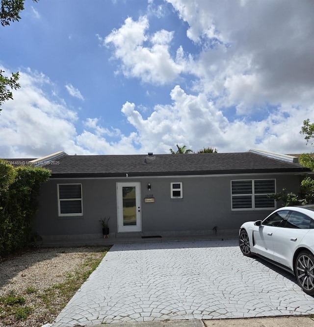 view of front of property featuring roof with shingles