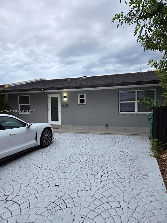 single story home featuring stucco siding