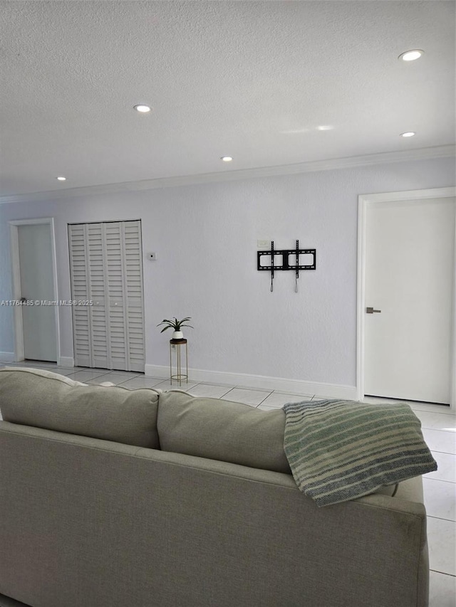 living room with light tile patterned flooring, recessed lighting, baseboards, and a textured ceiling