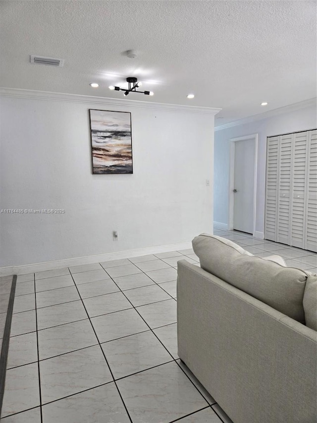 living room with crown molding, baseboards, visible vents, and a textured ceiling