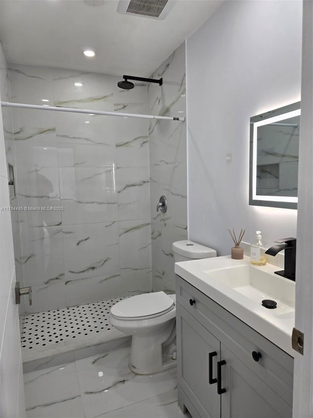 bathroom featuring a marble finish shower, marble finish floor, toilet, and vanity