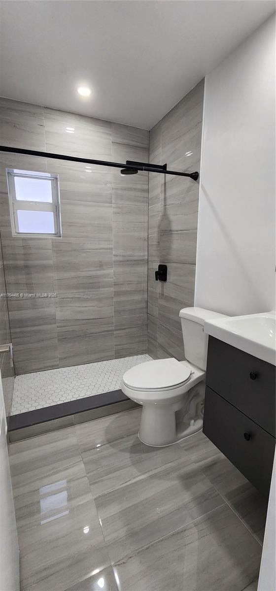 full bathroom featuring vanity, toilet, and a stall shower