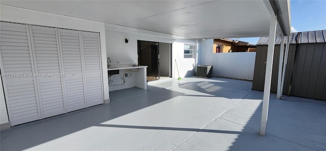 view of patio / terrace with a package area, cooling unit, and fence