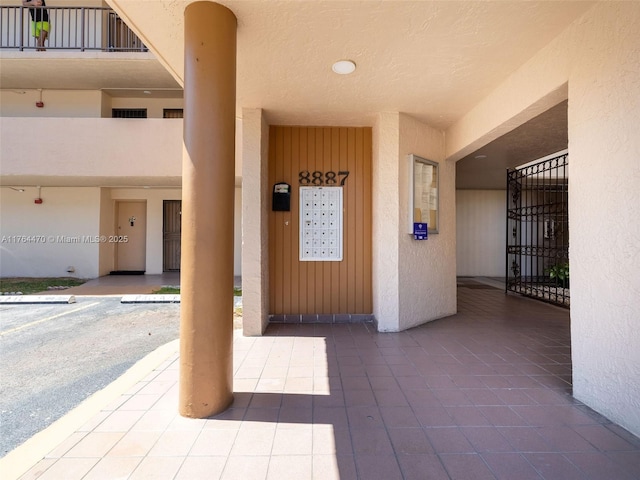 doorway to property featuring stucco siding