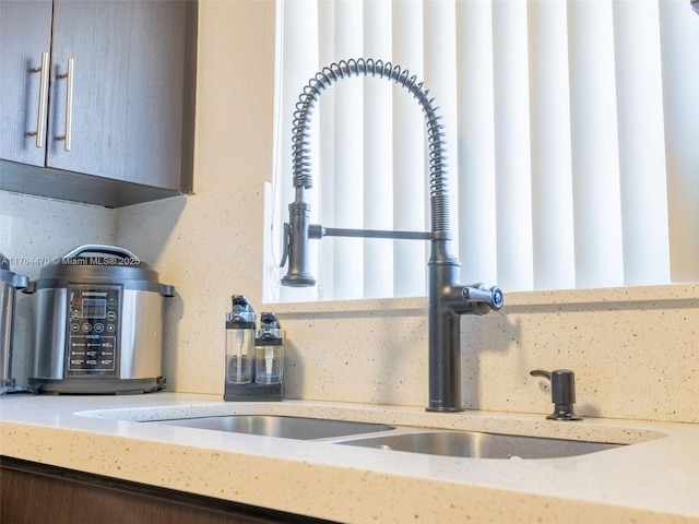 details with a sink and light stone countertops