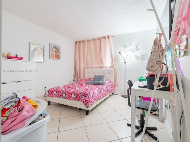 bedroom featuring light tile patterned flooring and a textured ceiling