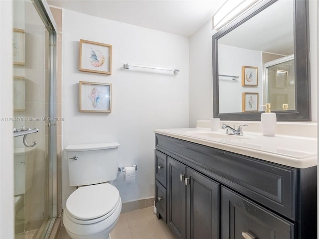 bathroom featuring vanity, baseboards, a stall shower, tile patterned floors, and toilet