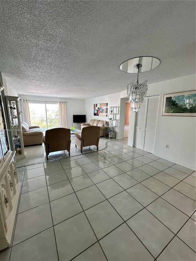 unfurnished living room featuring light tile patterned flooring, a notable chandelier, and a textured ceiling