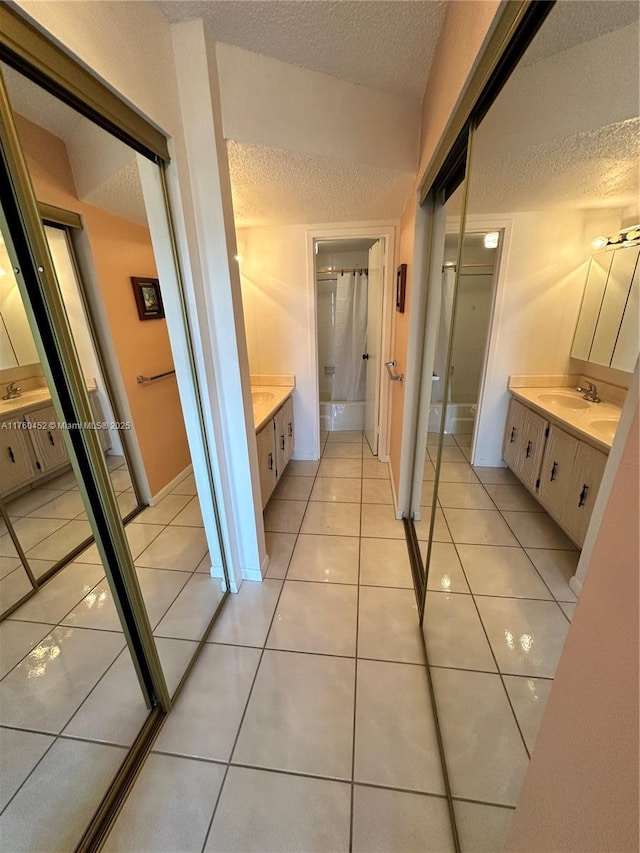 bathroom featuring tile patterned floors, a textured ceiling, and vanity