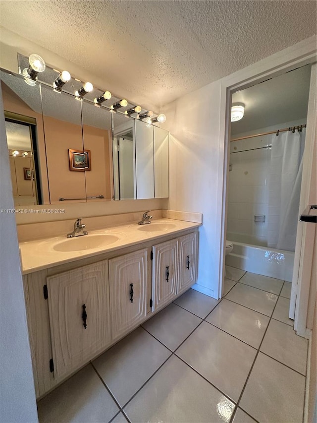 bathroom featuring a sink, a textured ceiling, and tile patterned flooring