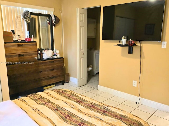 bedroom featuring light tile patterned floors and baseboards